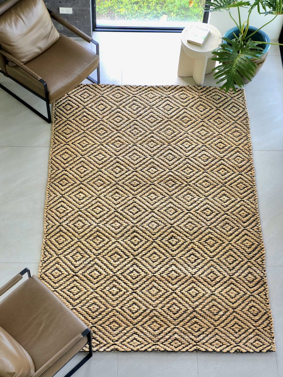 Diamond-weave abaca rug in a sitting area with two armchairs